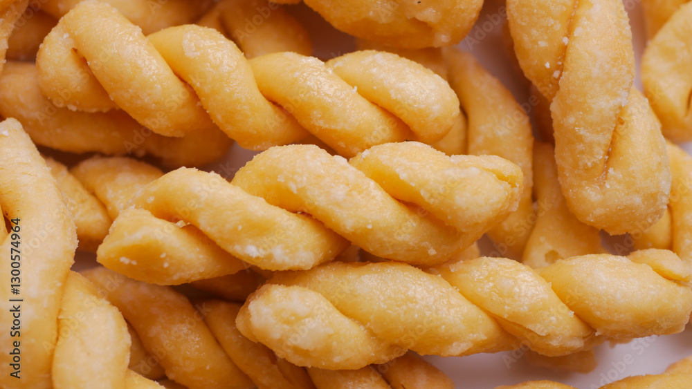Kue untir-untir or kue tambang isolated on white background, untir untir is a traditional Indonesian deep-fried twisted doughnut that has a sweet and crunchy taste, snack, cookies, crispy, delicious Kue untir-untir or kue tambang isolated on white background, untir untir is a traditional Indonesian deep-fried twisted doughnut that has a sweet and crunchy taste, snack, cookies, crispy, delicious