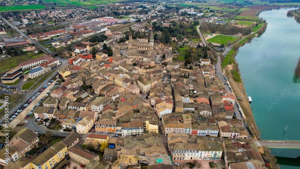 Aerial panoramic view around the old town of the city Tournus in France on a cloudy afternoon in spring.