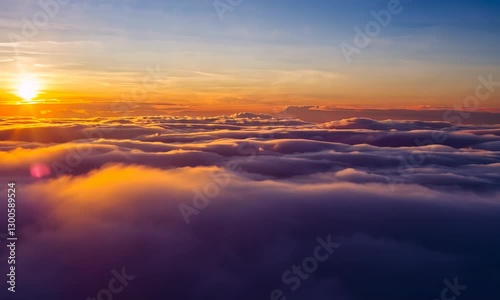 Aerial View of Clouds at Sunset with Warm Light Glow