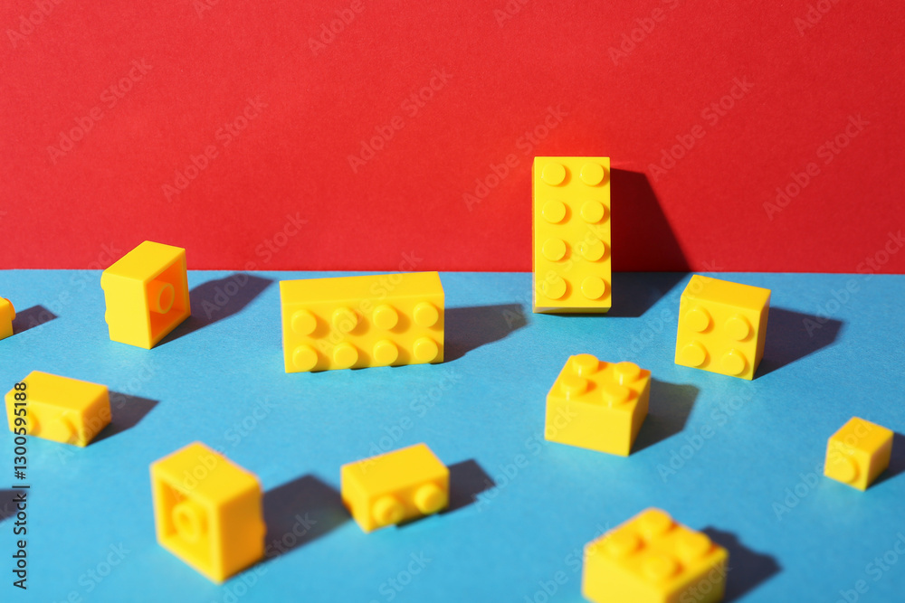 Obraz premium Construction toy. Bright building bricks on color background, closeup