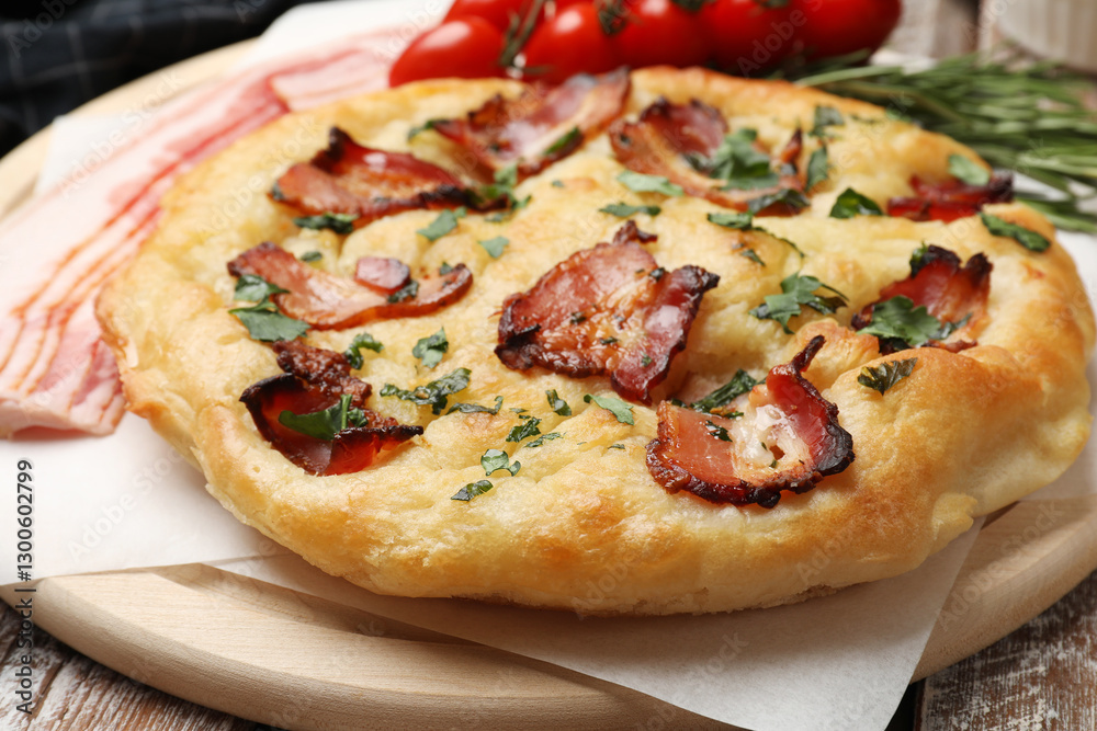 Delicious focaccia bread with bacon and parsley on wooden table, closeup Delicious focaccia bread with bacon and parsley on wooden table, closeup