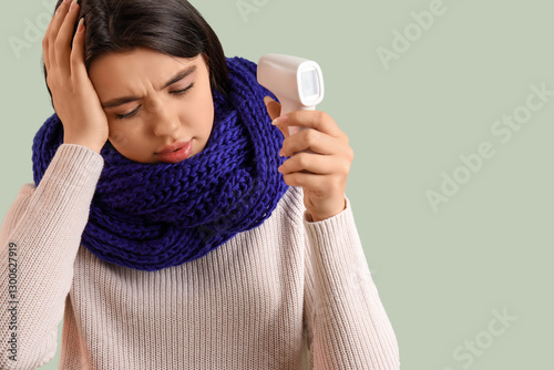 Sick young woman with therm...