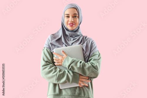 Young Muslim woman with lap...