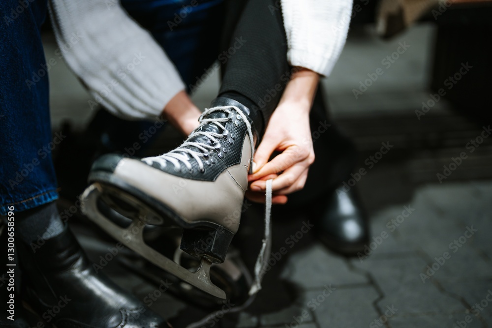 Fototapeta premium Preparing for a fun skating session on the ice rink during winter