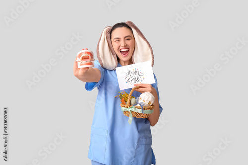 Happy female dentist in bun...