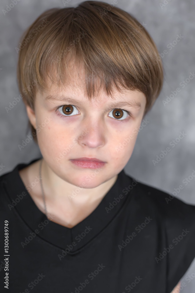 Portrait of a handsome blond boy with big brown eyes wearing a black sweatshirt Portrait of a handsome blond boy with big brown eyes wearing a black sweatshirt