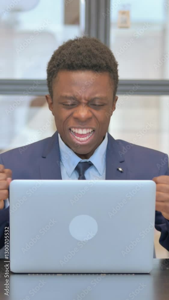 vertical video of African Businessman Celebrating Success on Laptop vertical video of African Businessman Celebrating Success on Laptop