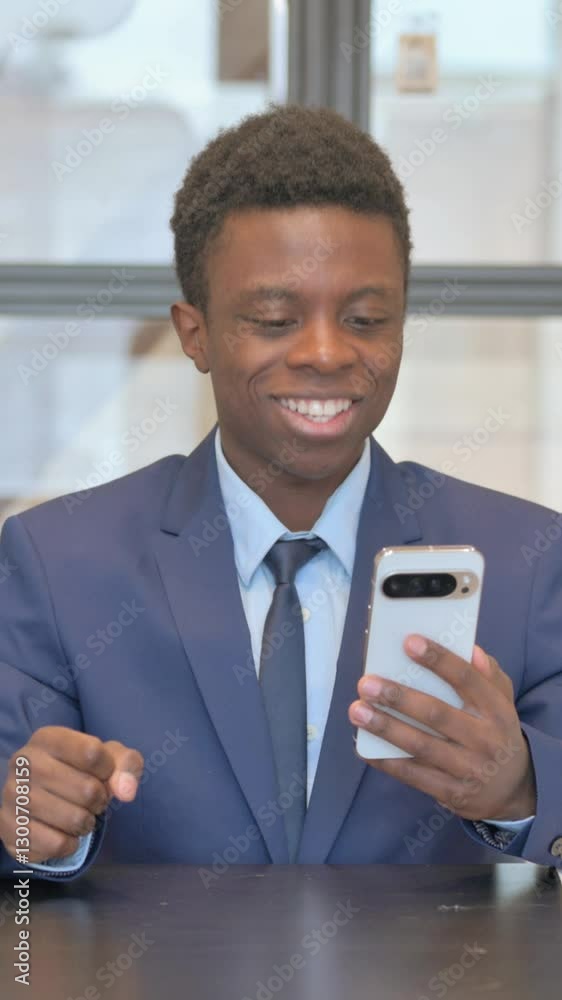 vertical video of African Businessman Celebrating Success on Phone in Office vertical video of African Businessman Celebrating Success on Phone in Office