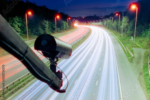 ANPR camera above a UK road, roadway, motorway, surveillance, light trails from moving traffic