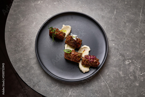 Obraz na płótnie Exquisite presentation of gourmet beef tartare topped with herbs and flowers on smoked mayonnaise, food styling concept w salonie