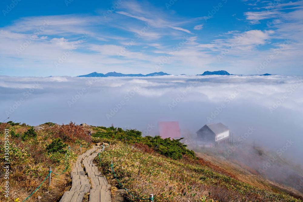 Hiking Route to Happo Pond and  the Japanese Alps mountains landscape with mist background on Hakuba Happo One in Hakuba, Nagano, Japan