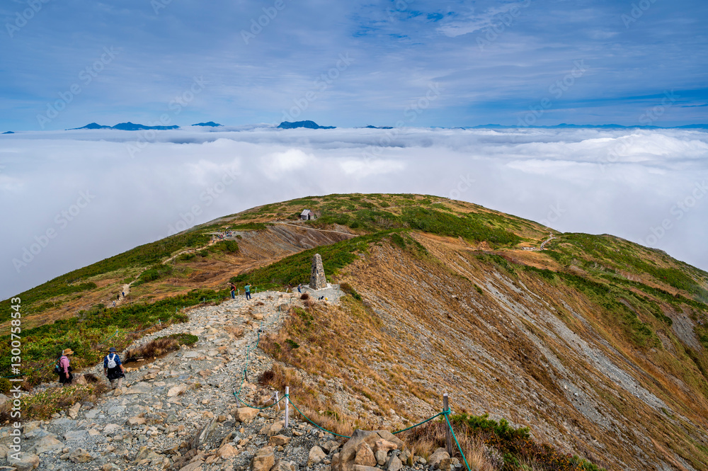 Hiking Route to Happo Pond and  the Japanese Alps mountains landscape with mist background on Hakuba Happo One in Hakuba, Nagano, Japan