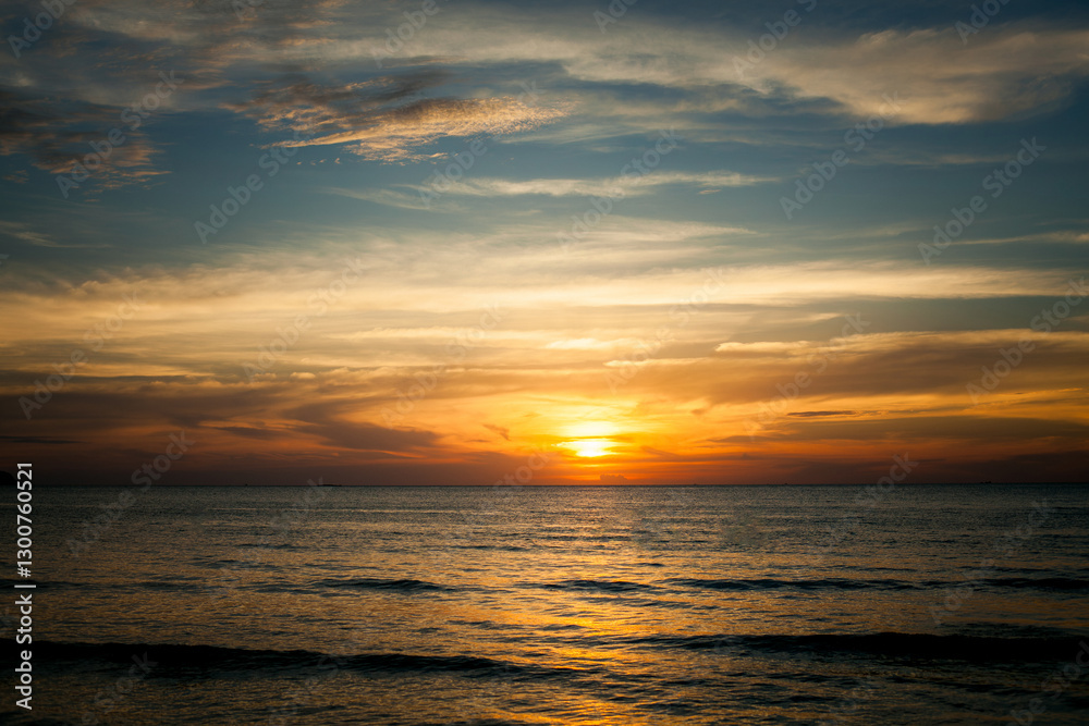A tropical seaside beach during a stunning sunset, radiating a calm and peaceful atmosphere.