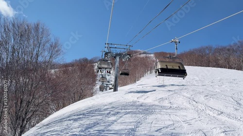 POV shot from a quad ski chairlift on a bright sunny day