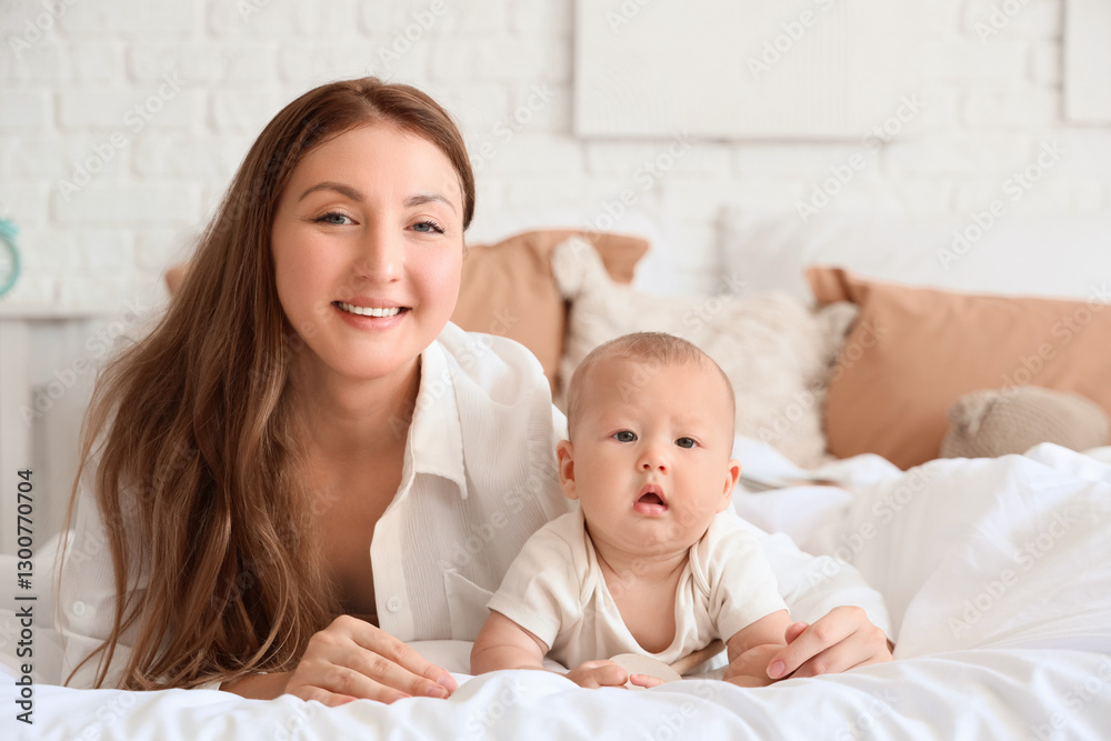 Mother with her baby lying on bed at home Mother with her baby lying on bed at home