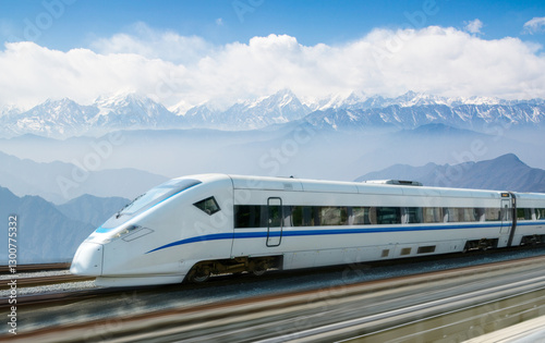 Wall Mural The high-speed train passes through the snow capped mountains