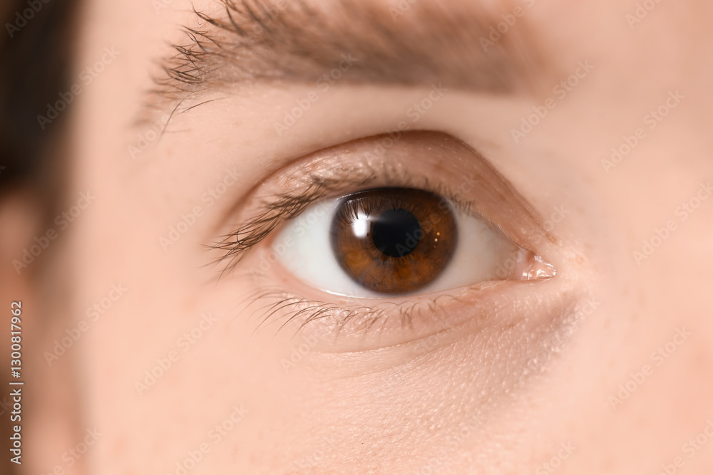 Obraz premium Face of young person with brown eyes, close up