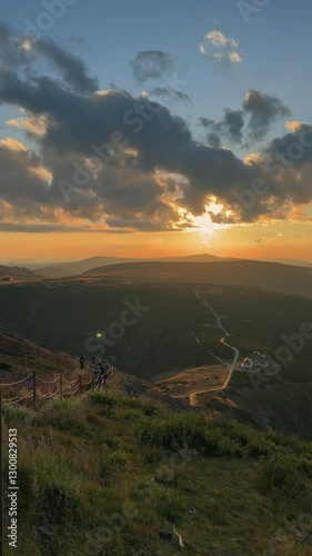 Breathtaking sunset view from mountain peak in serene landscape during golden hour