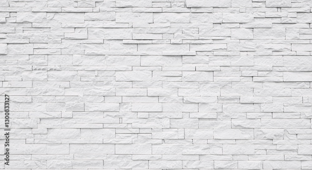 A high-resolution, full-frame image of a modern white stone veneer wall A high-resolution, full-frame image of a modern white stone veneer wall