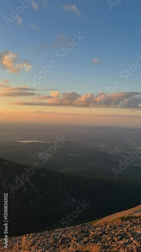 Stunning sunset over mountain landscape creates serene atmosphere in evening sky