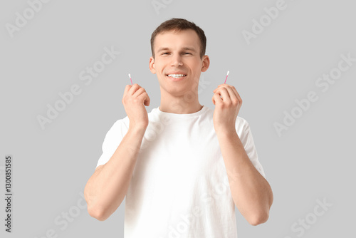 Young man with cotton buds ...