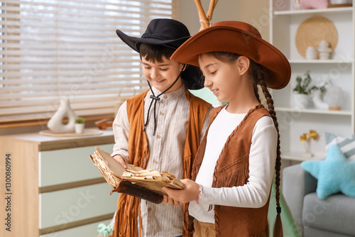 Young boy and girl in cowbo...