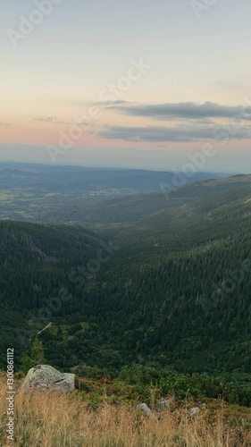 Mountain landscape at dusk showcasing rolling hills and distant valleys