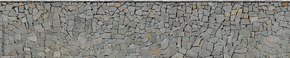 Fototapeta premium Stone texture of irregular gray basalt slabs dryjoint wall cladding