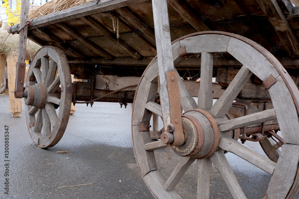 Wooden cart wheels display rustic charm on a rainy day Wooden cart wheels display rustic charm on a rainy day