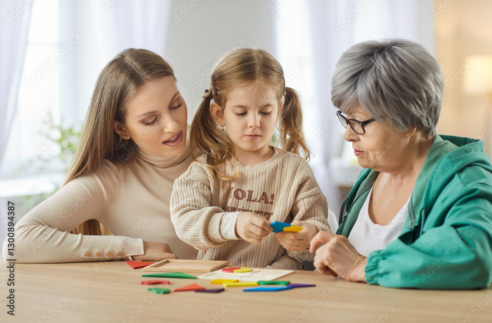 Happy mother, grandmother, and young daughter enjoying leisure time together at home, playing a board game. Warm family fun, bonding, and joyful interaction between three generations. Happy mother, grandmother, and young daughter enjoying leisure time together at home, playing a board game. Warm family fun, bonding, and joyful interaction between three generations.