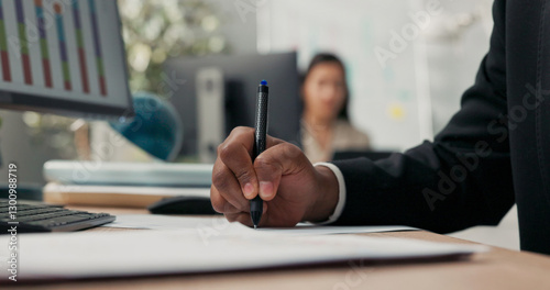 Close-up hand shot of dark-skinned man holding pen, signing documents, filling out application, cuffs of black suit, office scene, boss, manager, businessman gives consent, makes initial
