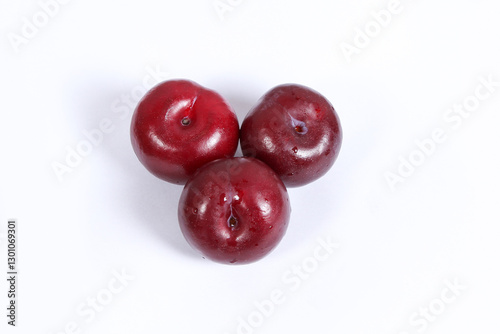 Fototapeta Naklejka Na Ścianę i Meble -  read plum fruits in white background  