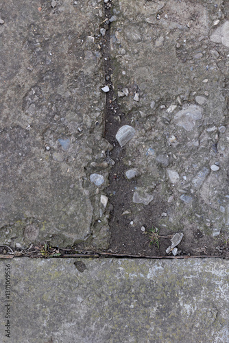 Background of destroyed concrete path, gray concrete, concrete texture, close-up. Natural photo. Old concrete slab