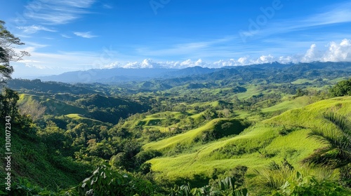 A breathtaking view of rolling green hills under a clear blue sky, capturing the tranquility of natural landscapes.