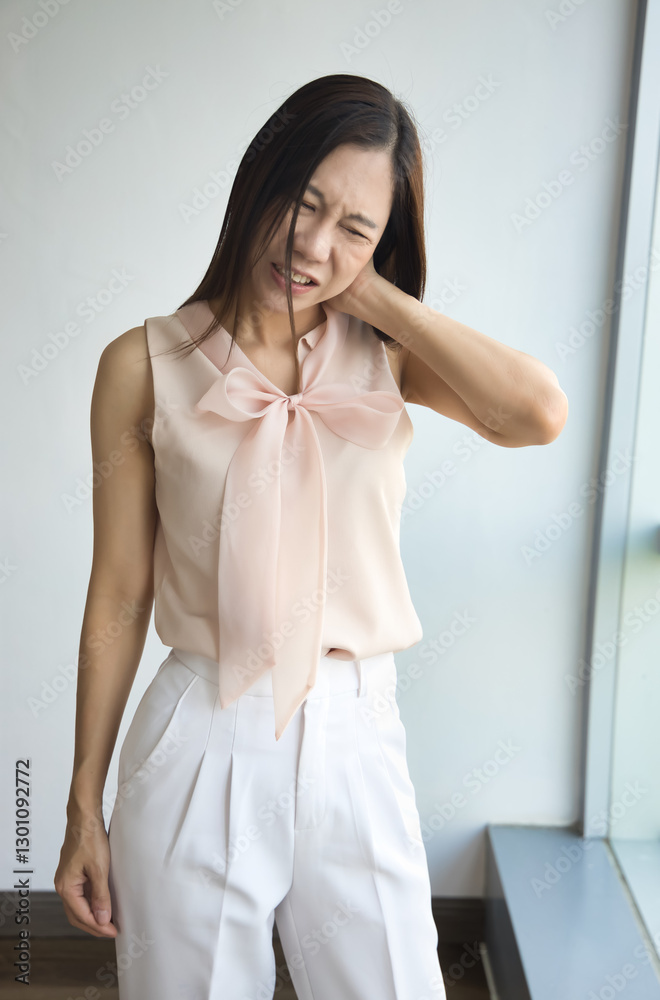 Middle aged asian woman having neck and shoulder muscle stiffness or neck pain from overwork, office syndrome, muscle cramp Middle aged asian woman having neck and shoulder muscle stiffness or neck pain from overwork, office syndrome, muscle cramp
