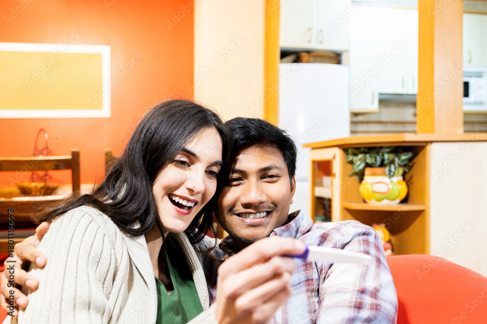 Excited couple celebrating positive pregnancy test at home. Lifestyle Excited couple celebrating positive pregnancy test at home. Lifestyle