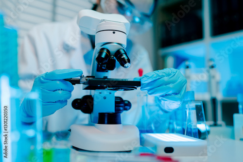Scientist is using a microscope to examine a sample