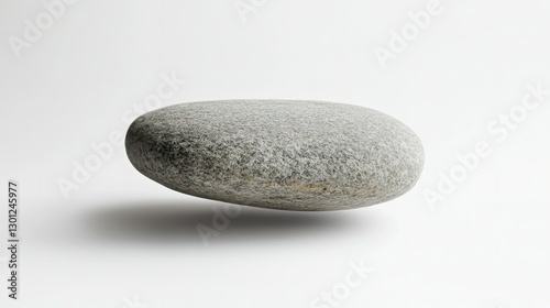 A smooth, gray river rock with a slight orange hue, photographed on a white background. The rock is casting a slight shadow.