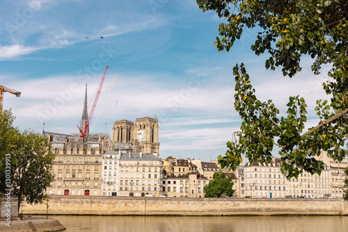 Obraz na płótnie View of seine river in paris with notre dame church under construction just over the river with visible cranes w salonie