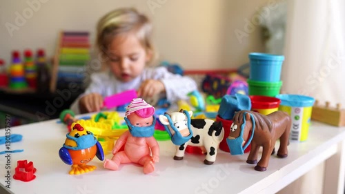 A child is having fun playing with toy play dough in a room, engaging in creative arts and crafts. The plastic material allows for artistic expression and imaginative play