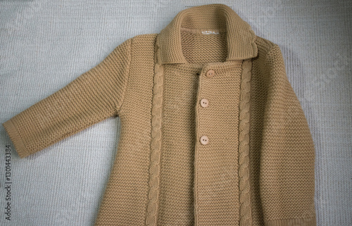 knitted baby sweater on white background