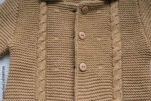 knitted baby sweater on white background