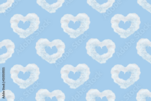 Seamless pattern of heart shaped clouds. Background of watercolor clouds on a blue sky.