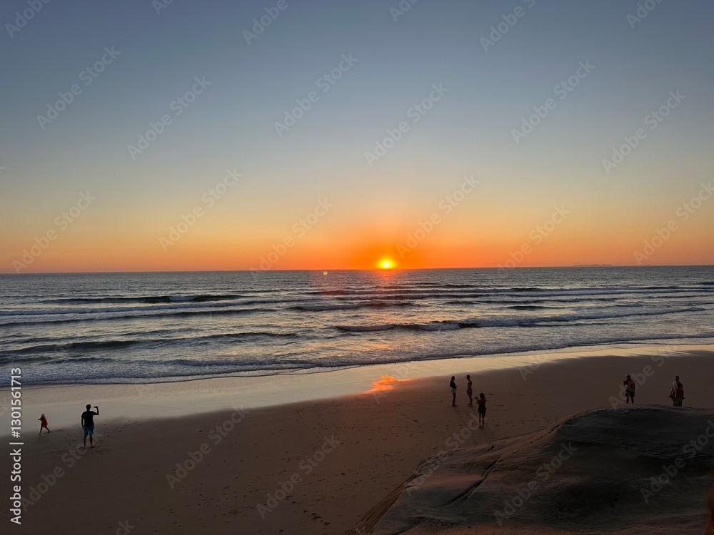 Sunset on a serene beach with gentle waves Sunset on a serene beach with gentle waves
