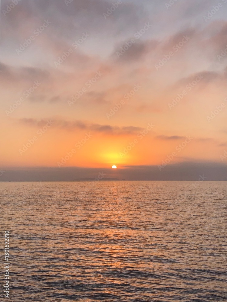 Obraz premium Golden sunset over calm ocean waters