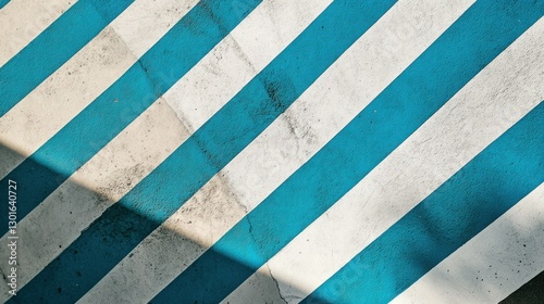 Diagonal blue and white painted stripes on a concrete surface, shadows