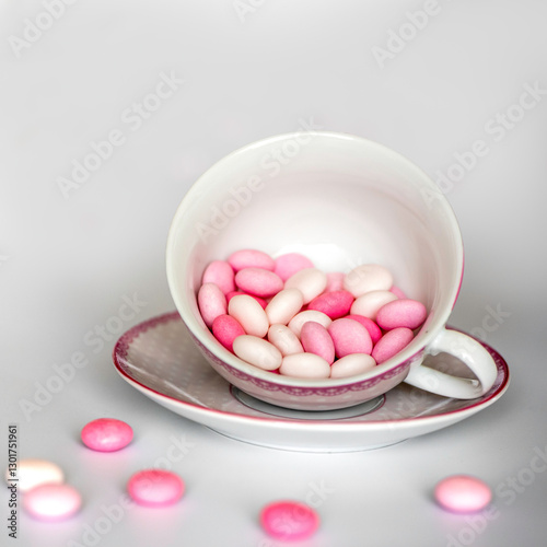 pink and white candy in a cup