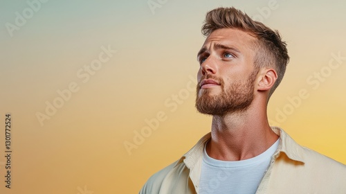 Thoughtful Young Man Gazing Upward at Sunset