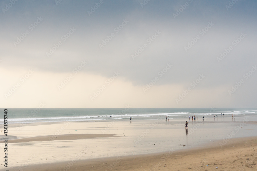 Beautiful beach scene with cloudy at sunset with people during vacation Beautiful beach scene with cloudy at sunset with people during vacation