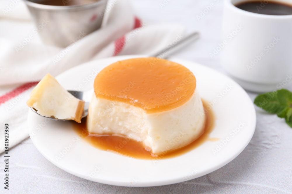 Tasty pudding with caramel sauce served on white textured table, closeup Tasty pudding with caramel sauce served on white textured table, closeup